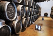 A multi-level 'Soleras' at Bodegas Lustau made up of at least three levels (probably more) and potentially hundreds of casks in each level. In the aisle are two arroba-sized (a specific unit of measurement) pitchers that were used to carry sherry from one criadera to another in the days before pumps.